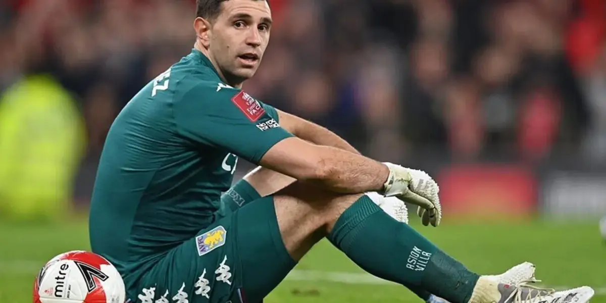 Emiliano Martínez sentado en el verde césped.